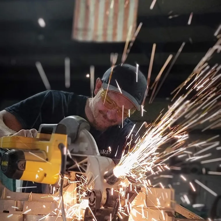 Matt Houle cutting material at a chop saw