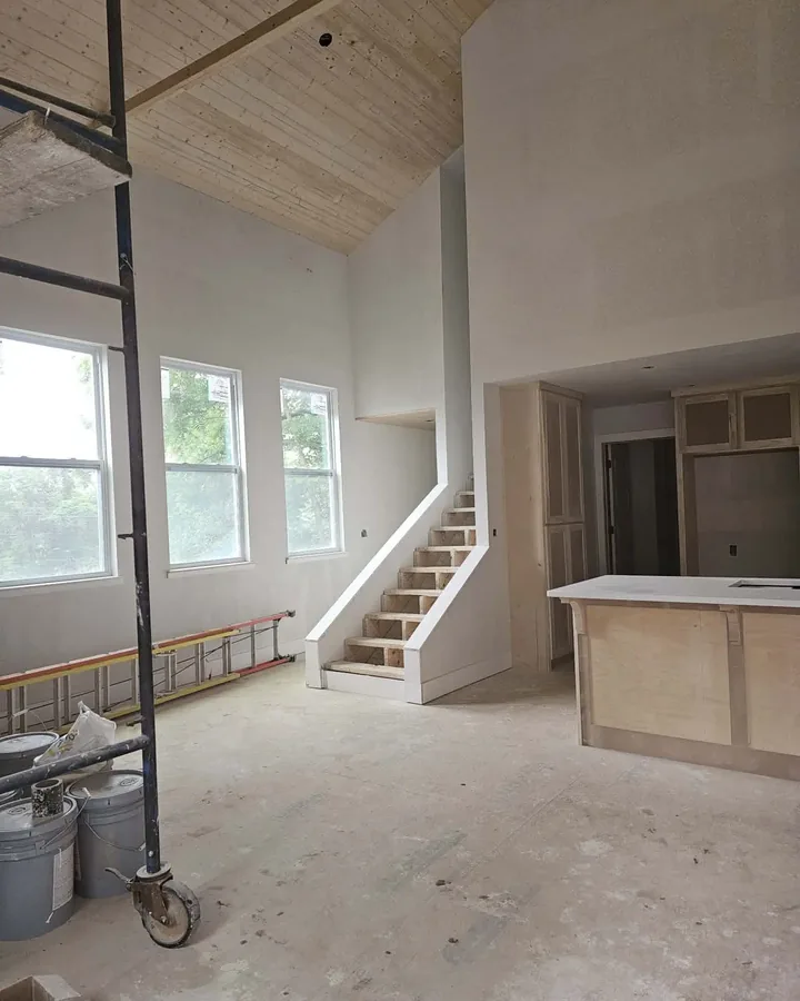Vaulted great room with fresh drywall ready for finishing