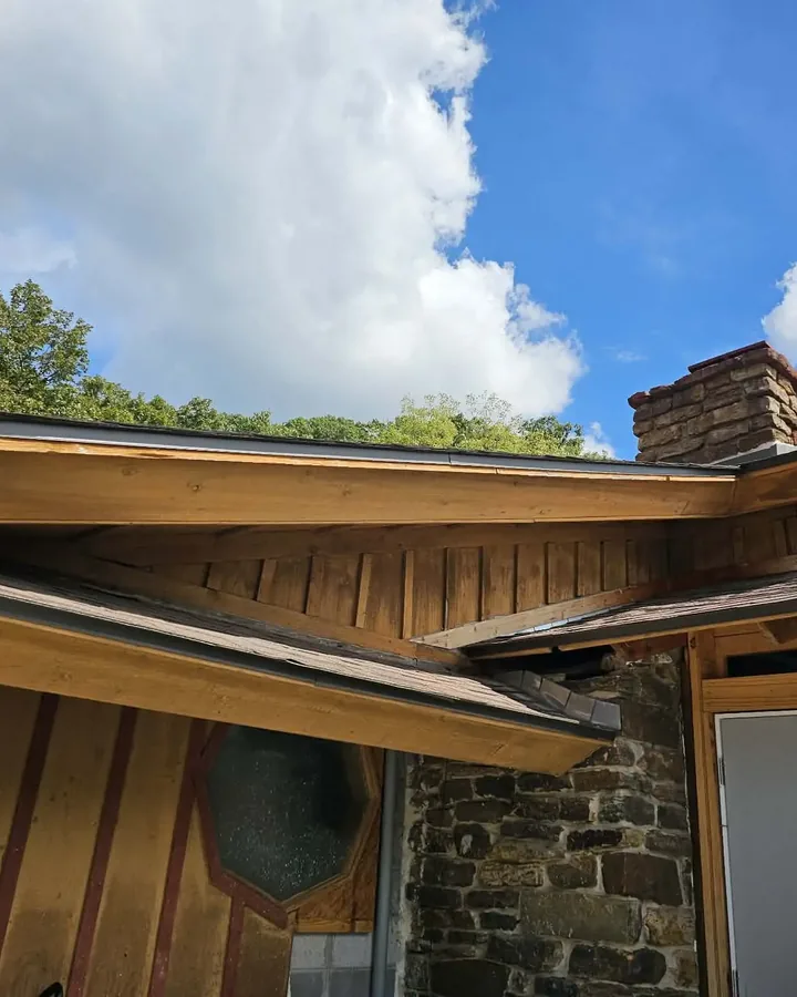 Roofline, soffit and cedar trim detail on a stone-clad home