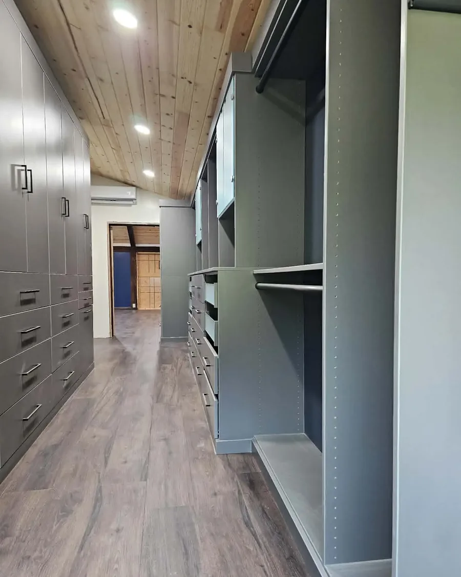 Custom built-in closet cabinetry along a hallway